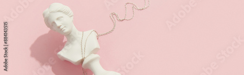 Creative composition with pendant on pink background. Trendy jewelry in minimalist style photo