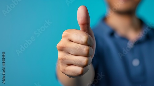 Thumbs Up Gesture Against a Blue Background