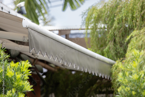 A white and silver awning with a white stripe and a black stripe photo