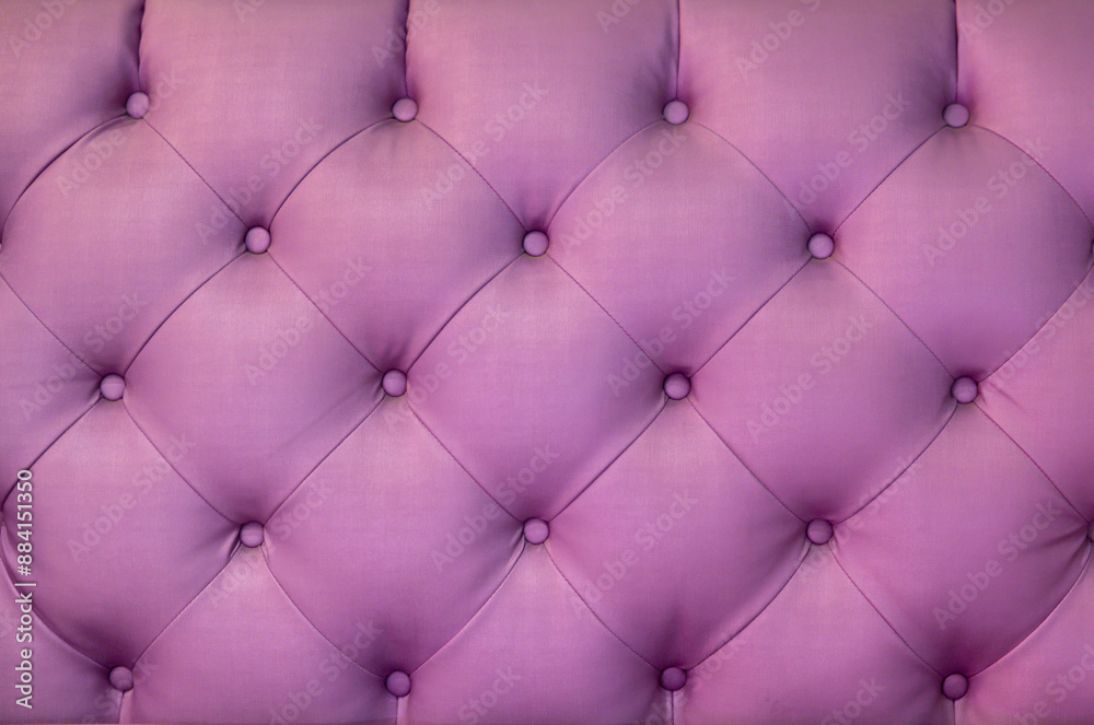 A purple velvet pillow with a pink background A purple velvet pillow with a pink background