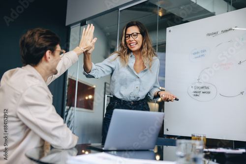 Business colleagues celebrating success with a high five