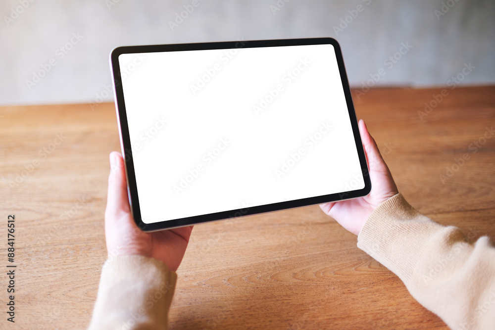 © Farknot Architect - Mockup image of a woman holding digital tablet with blank white desktop screen