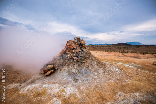 Boiling mudpots in the geothermal area Hverir and cracked ground around. Location: geothermal area Hverir, Myvatn region, North part of Iceland photo