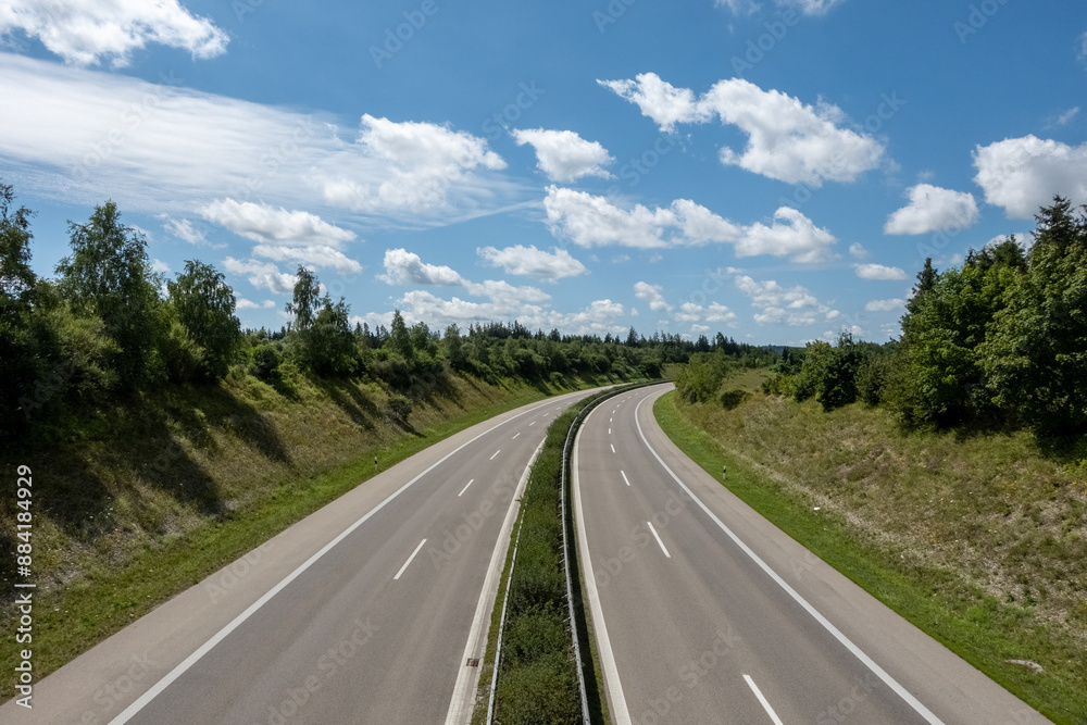4 lane highway road at countryside against blue sky with fair weather clouds 4 lane highway road at countryside against blue sky with fair weather clouds