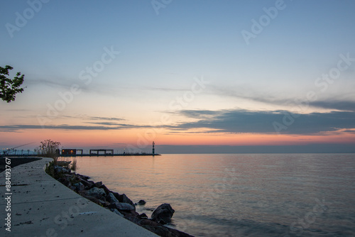 Sunrise on the shore and harbor of a lake in summer. Colorful sky with a wide view of the Horiont. Nature landscape at Tihany marina, Balaton, Lake Balaton, Siófok, Hungary photo