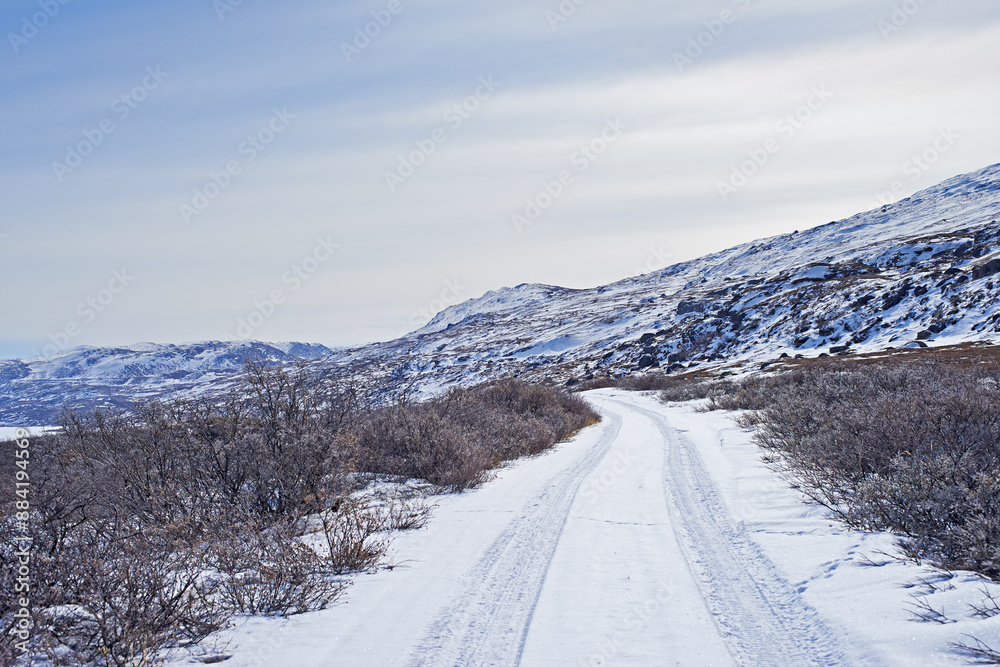 Landscape, road and mountains with snow, sky or transportation in Kangerlussuaq, Greenland, Denmark. Winter, ice and highway by hill for infrastructure with horizon, travel and path with mockup space Landscape, road and mountains with snow, sky or transportation in Kangerlussuaq, Greenland, Denmark. Winter, ice and highway by hill for infrastructure with horizon, travel and path with mockup space