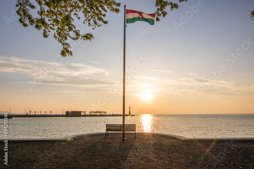 Sunrise on the shore and harbor of a lake in summer. Colorful sky with a wide view of the Horiont. Nature landscape at Tihany marina, Balaton, Lake Balaton, Siófok, Hungary photo