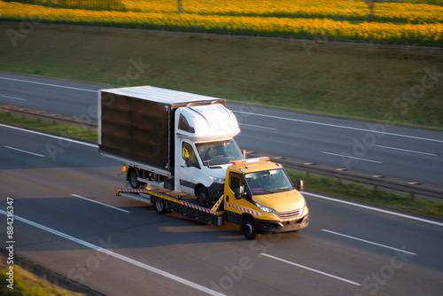 Quadro em tela Commercial Cargo Vehicle Bus Transportation By Towing Truck Flatbed