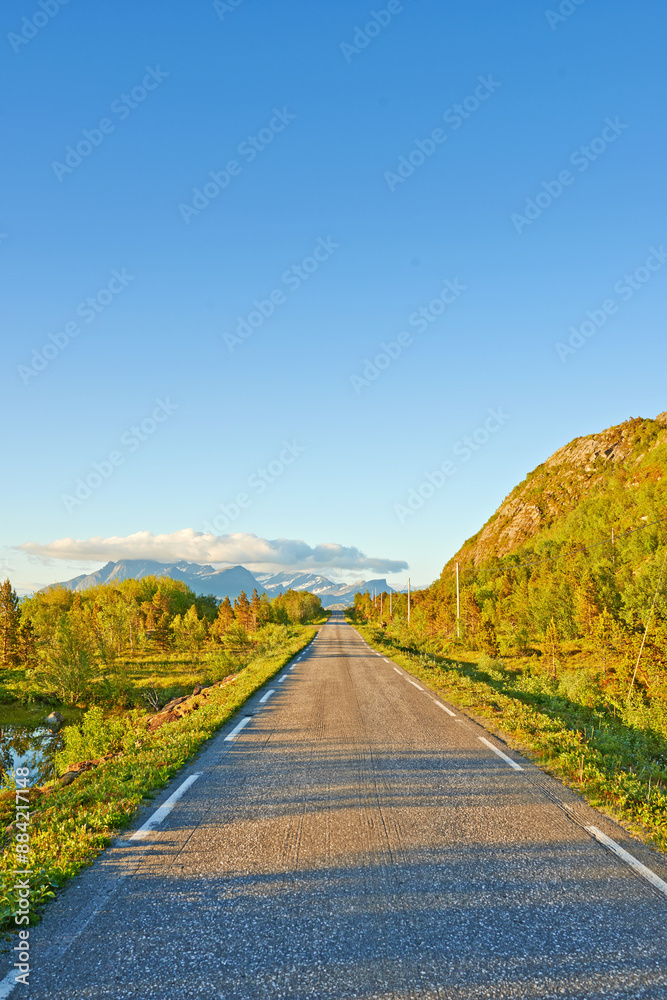 Naklejka premium Nature, road and sky with clouds by mountains, fjord and trees for transport system in summer. Landscape, mockup and space with highway, infrastructure and travel in environment by street in Norway
