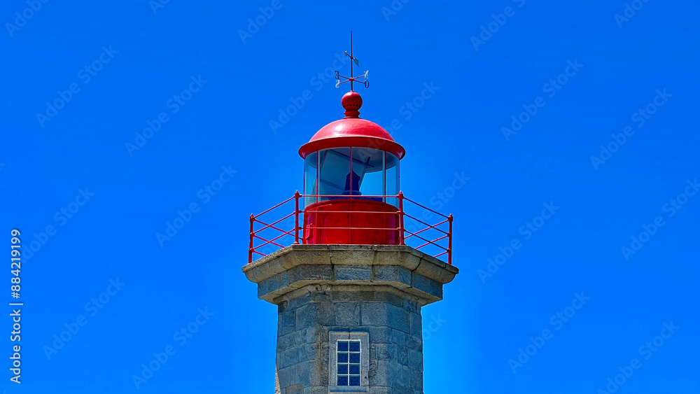 a lighthouse sits on a ledge overlooking the water a lighthouse sits on a ledge overlooking the water