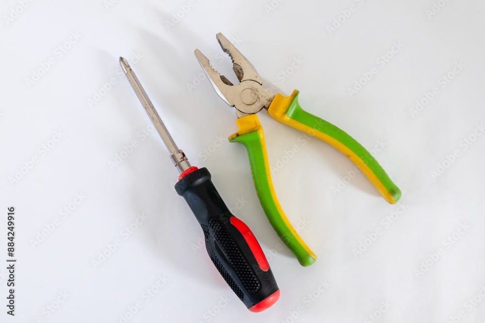 Screwdriver and pliers isolated on white background Screwdriver and pliers isolated on white background