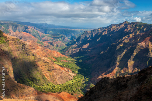 Obraz na płótnie Panoramic view of Waimea Canyon on the Hawaiian island of Kauai, USA against blue sky with clouds w salonie