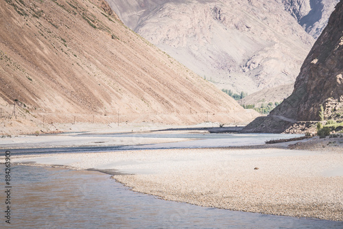 The Panj River flows between Afghanistan and Tajikistan along the Pamir Highway road in the Tien Shan mountains