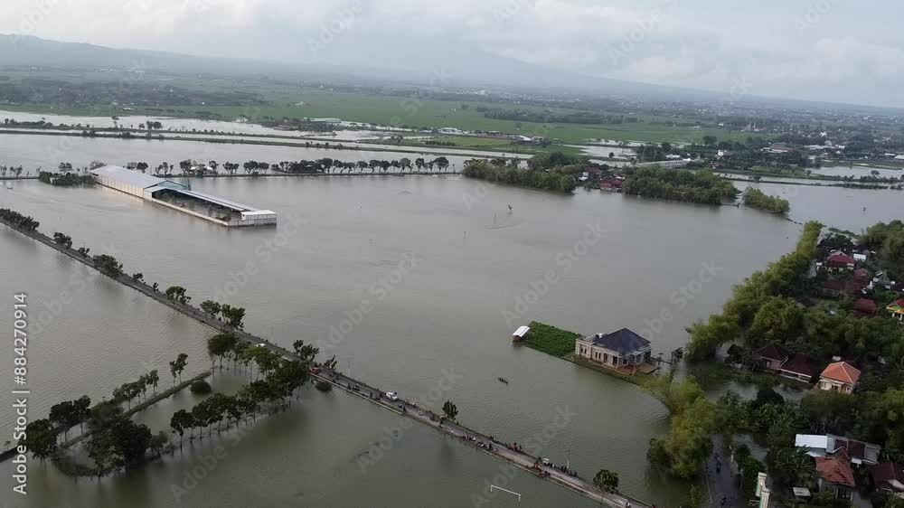 Aerial view of flooded rural area with submerged buildings Aerial view of flooded rural area with submerged buildings