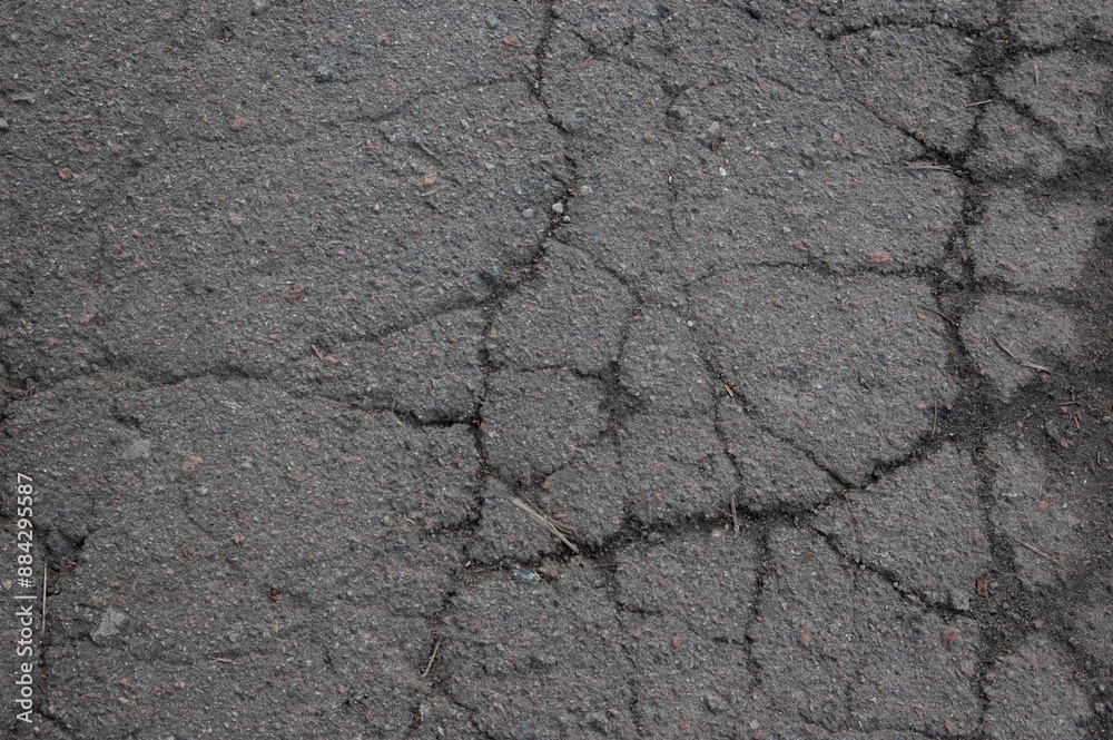 Obraz premium an old cracked asphalt pathway