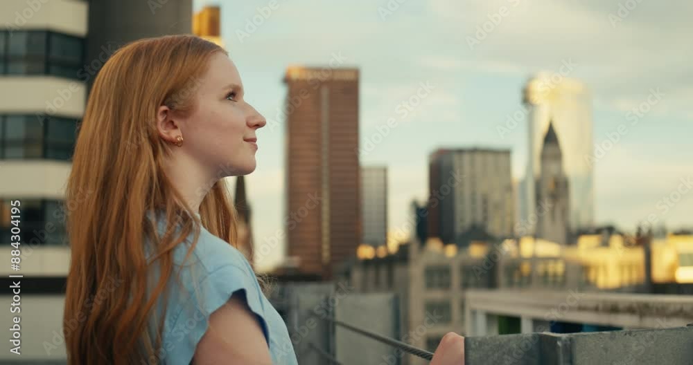 Young woman admiring downtown city buildings and scenery during sunset Young woman admiring downtown city buildings and scenery during sunset