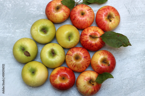 Beautiful green and red apples top view photo. Juicy organic fruit on light grey textured background with space for text. Healthy eating concept. 