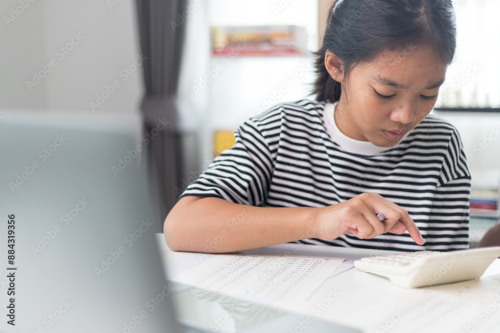 Asian elementary school children studying mathematics in class intently. Asian elementary school children studying mathematics in class intently.