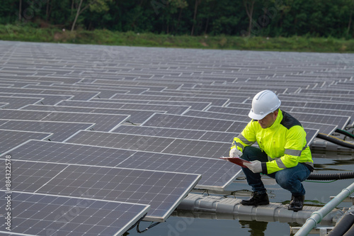 Wallpaper Mural Engineer working at floating solar farm,checking and maintenance with solar batteries near solar panels,supervisor Check the system at the solar power station Torontodigital.ca