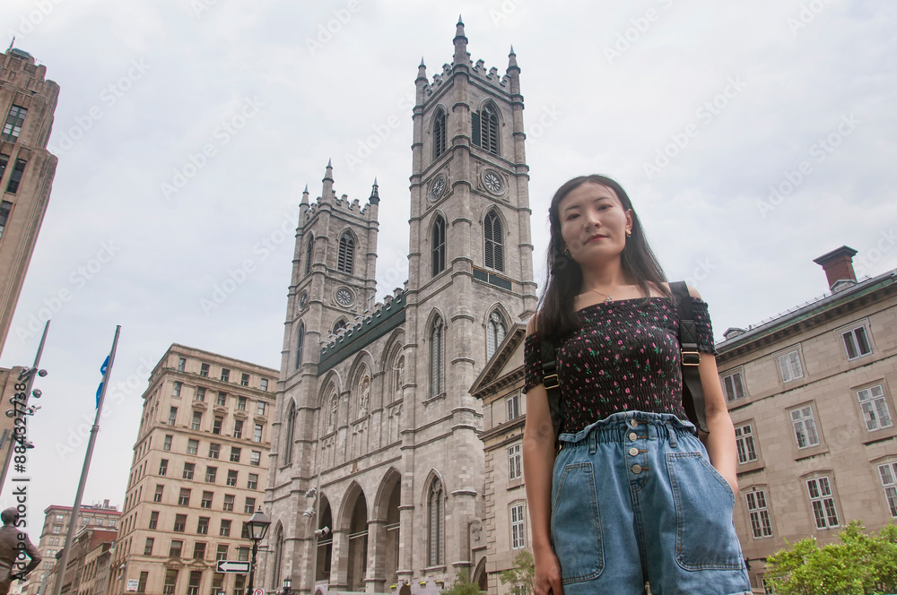 Fototapeta premium chinese woman standing in front of Notre Dame Cathedral Montreal