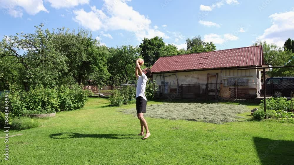 Volleyball player practices volleyball skills with a ball on an outdoor grass court. Passing, hitting, digging. Automation of movement. Special drills Volleyball player practices volleyball skills with a ball on an outdoor grass court. Passing, hitting, digging. Automation of movement. Special drills