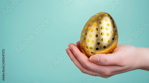 close-up of hand holding a large golden egg, symbolizing sudden wealth photo