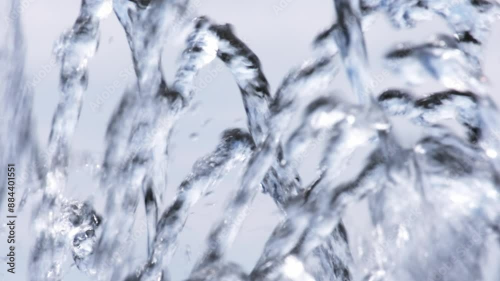 Clear and fresh water against white background. Slow motion close-up of a fountain. Beautiful translucent flowing water. Relaxation, hot summer weather, lack of water concept. Clear and fresh water against white background. Slow motion close-up of a fountain. Beautiful translucent flowing water. Relaxation, hot summer weather, lack of water concept.