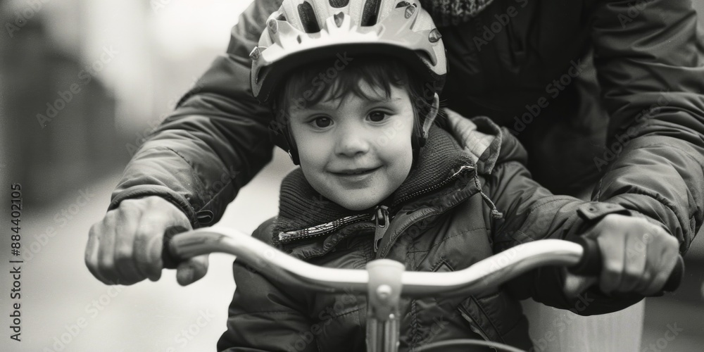 A young boy rides a bicycle while wearing a helmet, emphasizing safety and fun A young boy rides a bicycle while wearing a helmet, emphasizing safety and fun