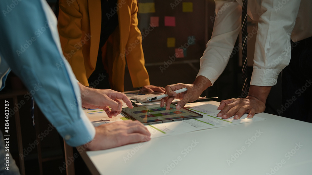 Diverse business team collaborating on project with tablet in well lit office meeting, analyzing data, brainstorming, and reaching decisions. Effective teamwork, innovation, and collaboration Diverse business team collaborating on project with tablet in well lit office meeting, analyzing data, brainstorming, and reaching decisions. Effective teamwork, innovation, and collaboration
