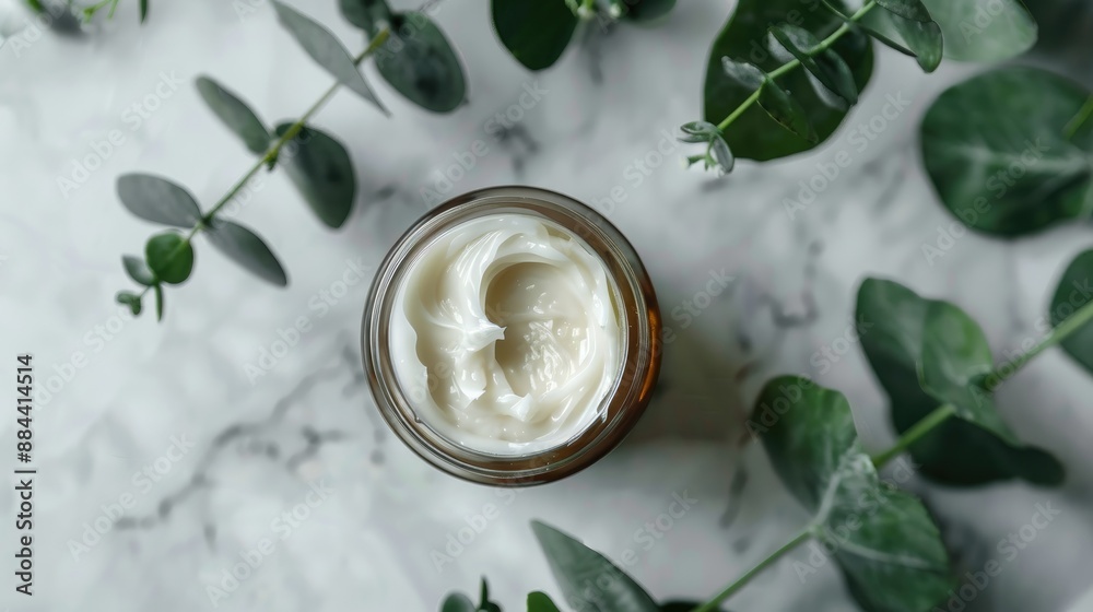 Healing face cream for troubled skin in open jar with visible texture decorated with eucalyptus leaf Healing face cream for troubled skin in open jar with visible texture decorated with eucalyptus leaf