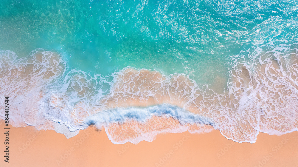 Aerial view of turquoise ocean waves crashing onto a sandy beach. Aerial view of turquoise ocean waves crashing onto a sandy beach.