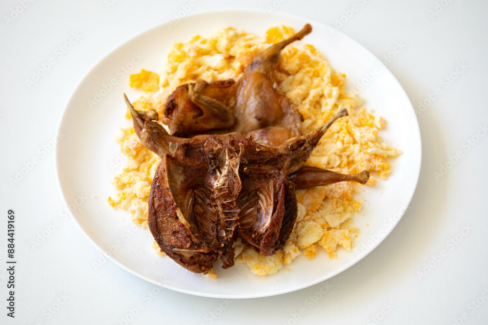 Quail prepared on a plate with pasta and egg crumbs Quail prepared on a plate with pasta and egg crumbs