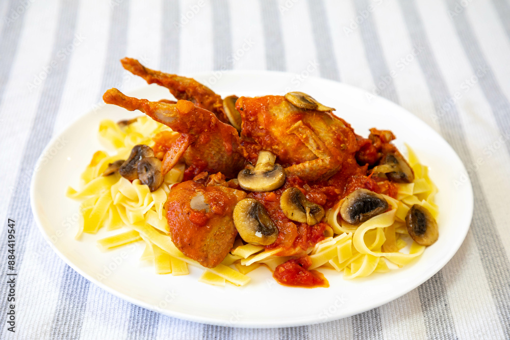 Quail prepared on a plate with pasta and egg crumbs Quail prepared on a plate with pasta and egg crumbs