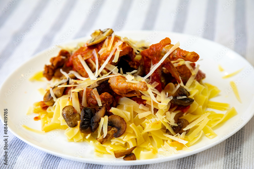 Quail prepared on a plate with pasta and egg crumbs Quail prepared on a plate with pasta and egg crumbs