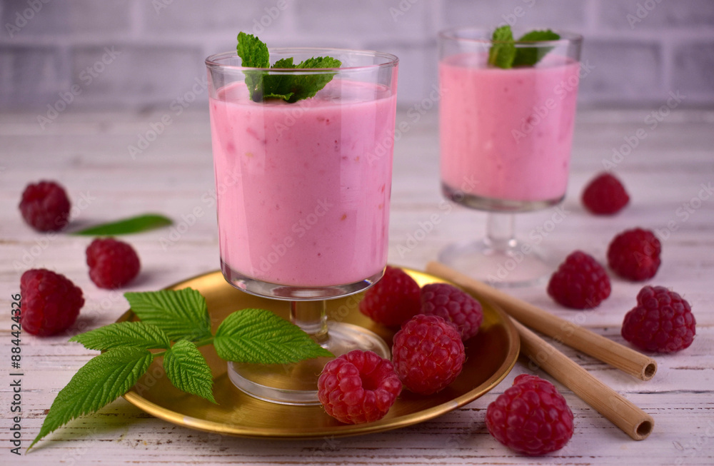 Raspberry smoothie with mint on a white wooden background. Raspberry smoothie with mint on a white wooden background.