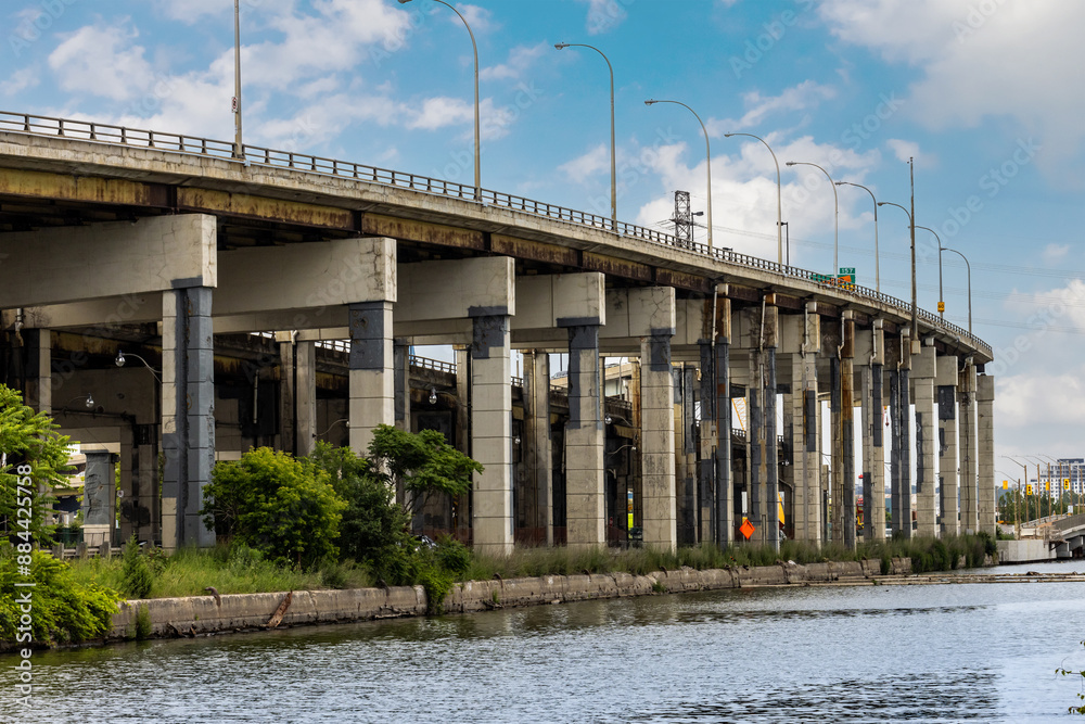 The patched and repaired supporting concrete structures of the East section of the Toronto Gardiner Expressway seen from the Villiers Island in the port lands The patched and repaired supporting concrete structures of the East section of the Toronto Gardiner Expressway seen from the Villiers Island in the port lands