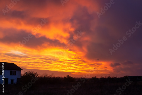 Rural sky landscape. Bright sky with clouds after sunset over the village.