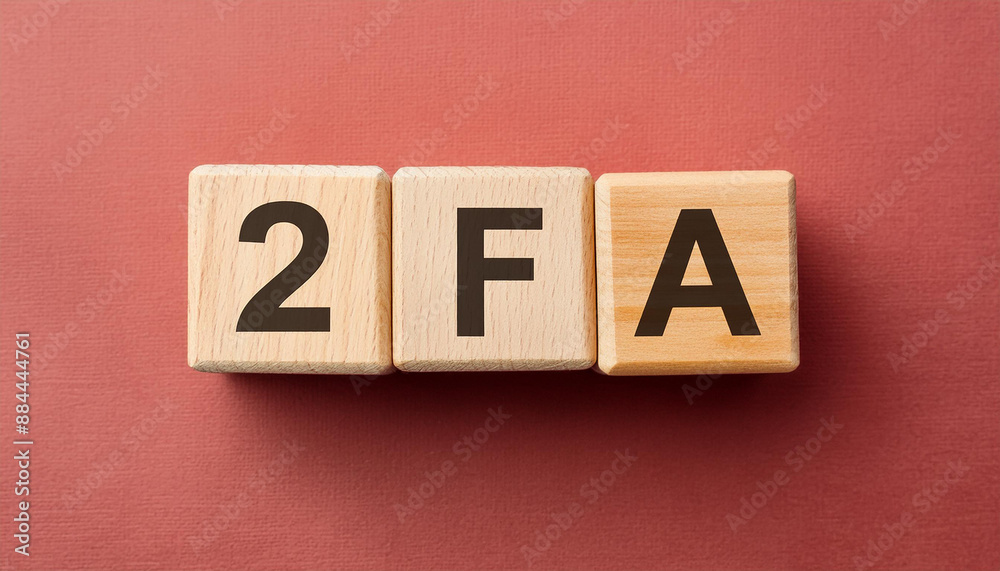 Obraz premium Wooden cubes with abbreviation 2FA, red background. Two-Factor Authentication. Online security