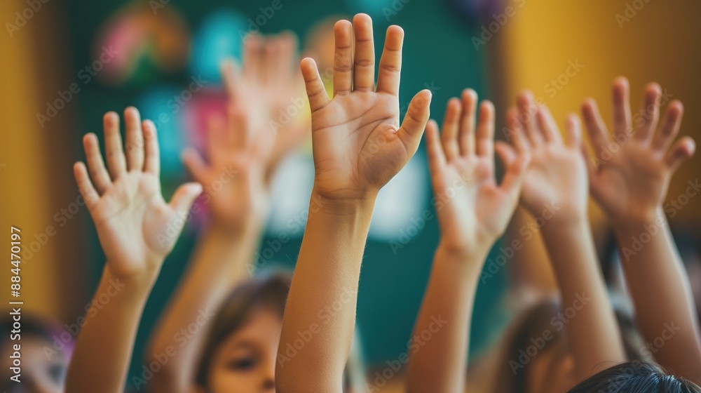 Children raise their hands to answer in the classroom. Back To School concept Children raise their hands to answer in the classroom. Back To School concept
