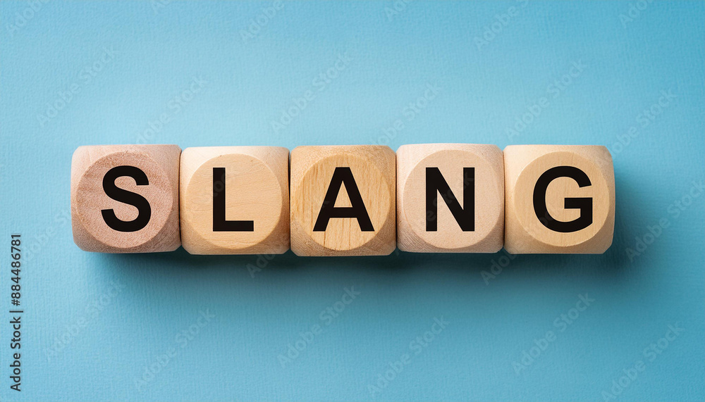 Wooden cubes with text SLANG, blue backdrop. Wood block. Close-up. Flat lay, top view. Wooden cubes with text SLANG, blue backdrop. Wood block. Close-up. Flat lay, top view.