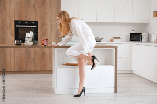 Hurrying young woman dressi...