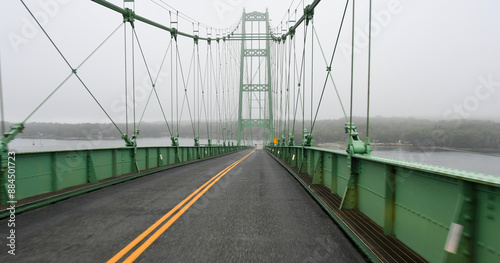 The Deer Isle Bridge in Sedgwick, Maine on a foggy morning as it spans across Eggemoggins Reach to Little Deer Isle photo