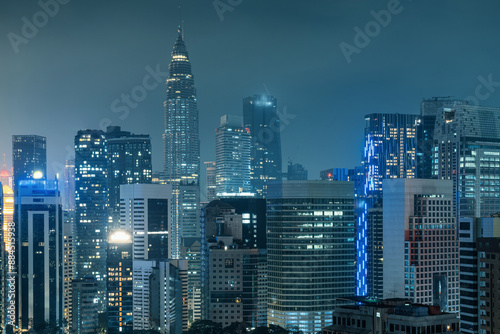 Photography Kuala Lumpur city skyline with twin tower, high-rise buildings and skyscrapers at night, Malaysia