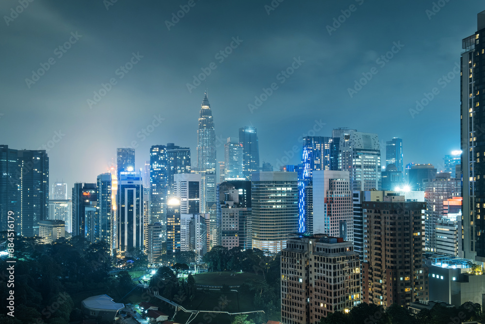 Obraz premium Aerial view of Kuala Lumpur city with high-rise buildings and skyscrapers at night, Malaysia. Cityscape of Asian city with modern architecture. Travel and tourism background