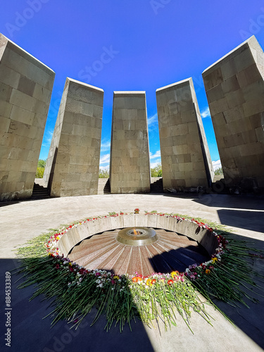 ARMENIA, YEREVAN - MAY 4, 2023: Flowers lie next to eternal fire in the memorial of 1915 Tsitsernakaberd photo