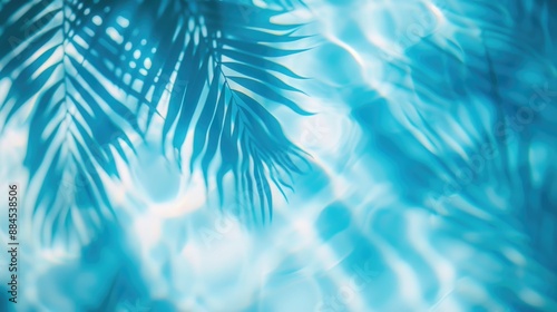 Tropical leaf shadow on water surface. Shadow of palm leaves on blue water. Beautiful abstract background concept banner for summer vacation at the beach