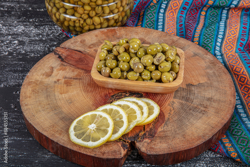 Homemade crushing olive making. Fresh green olives are breaking one by one. Crushing olives with stone. Preparing pickled olives in Turkish style. (Turkish name; kirma zeytin). Pickled Green Olives. photo