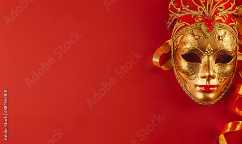 Golden Venetian Mask with Red Ribbon on Red Background. © SunPunjiStudio