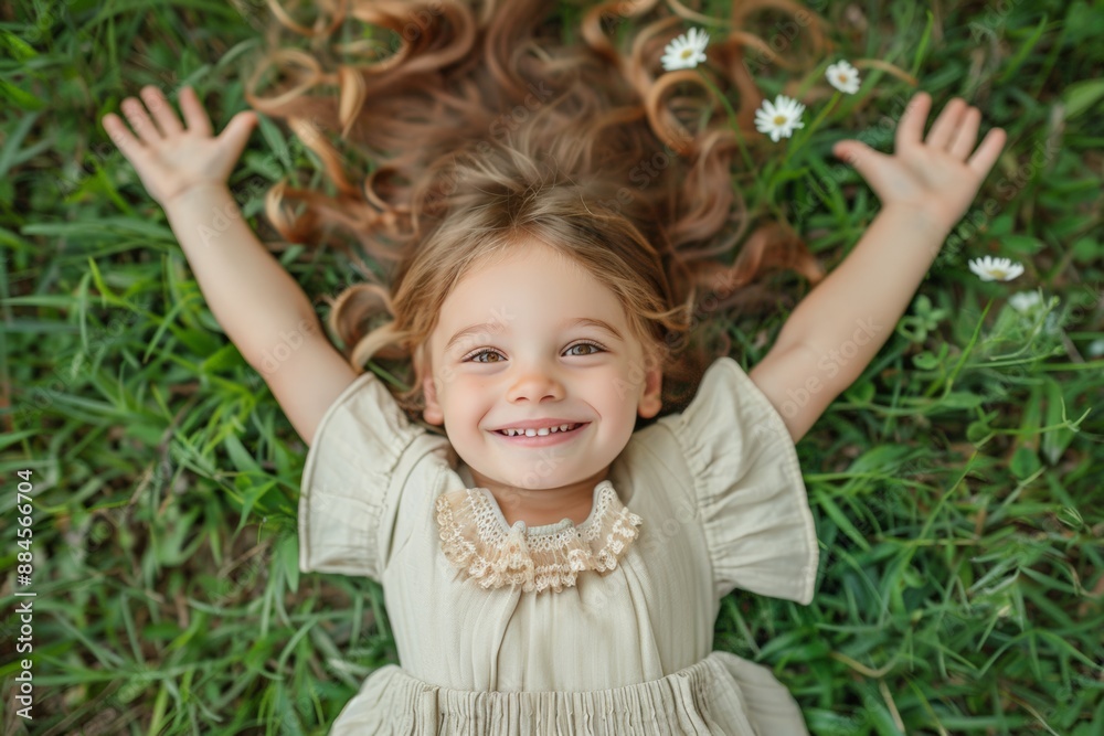 Smiling little girl lying on grass with flowers in her hair. Smiling little girl lying on grass with flowers in her hair.