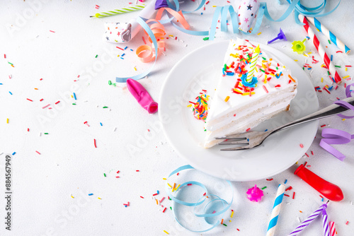 Birthday cake slice on birthday party decorated table